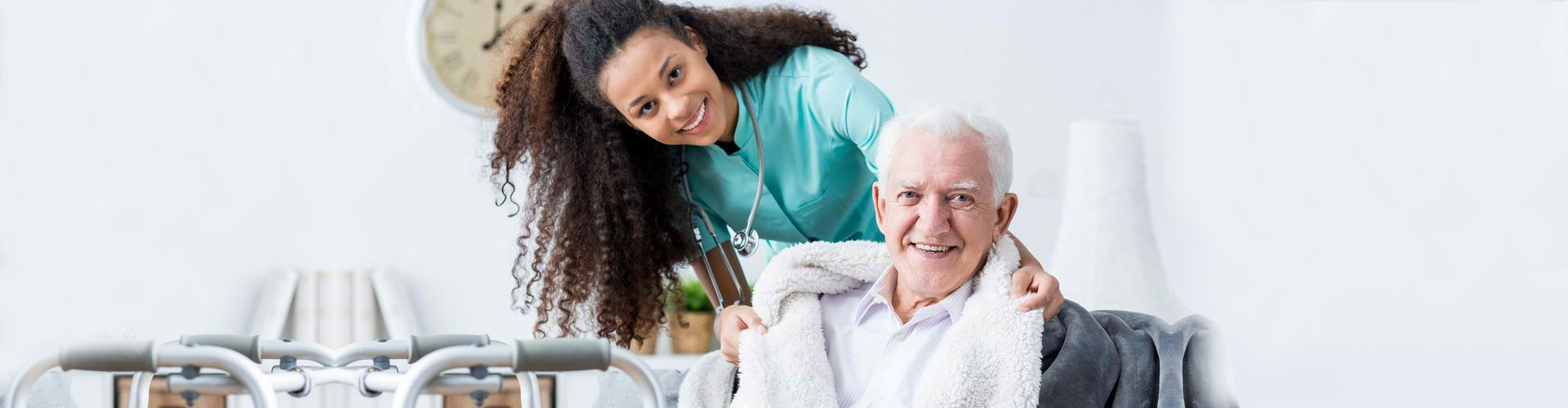 a caregiver and a senior man smiling